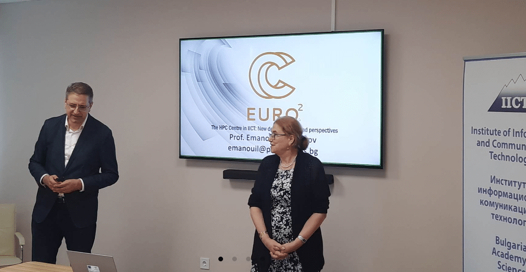 Woman and Man standing in front of a presentation with cover slide